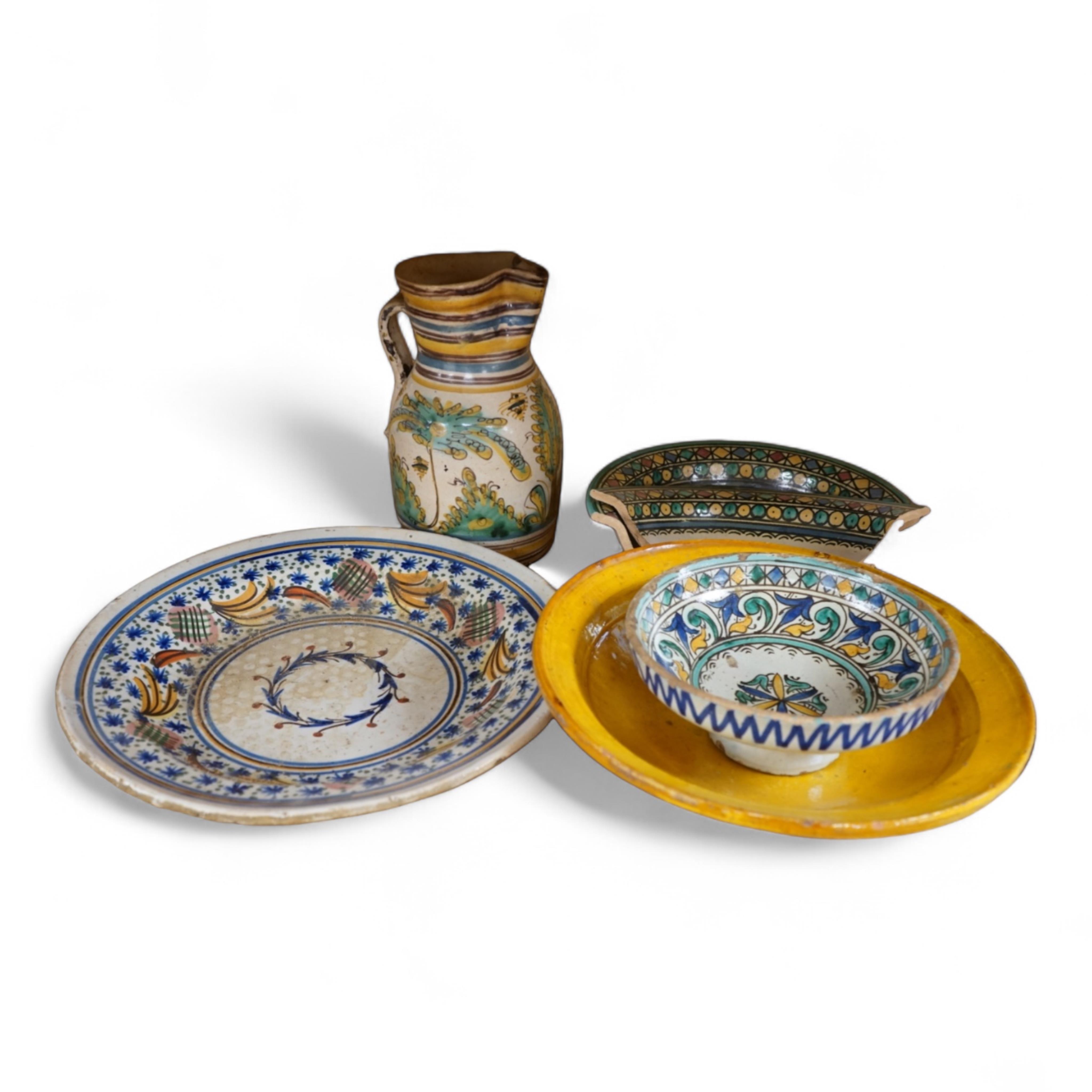 A late 17th century Spanish tin glazed jug together with Moroccan and pottery bowls and dishes (5). Jug 26cm high.